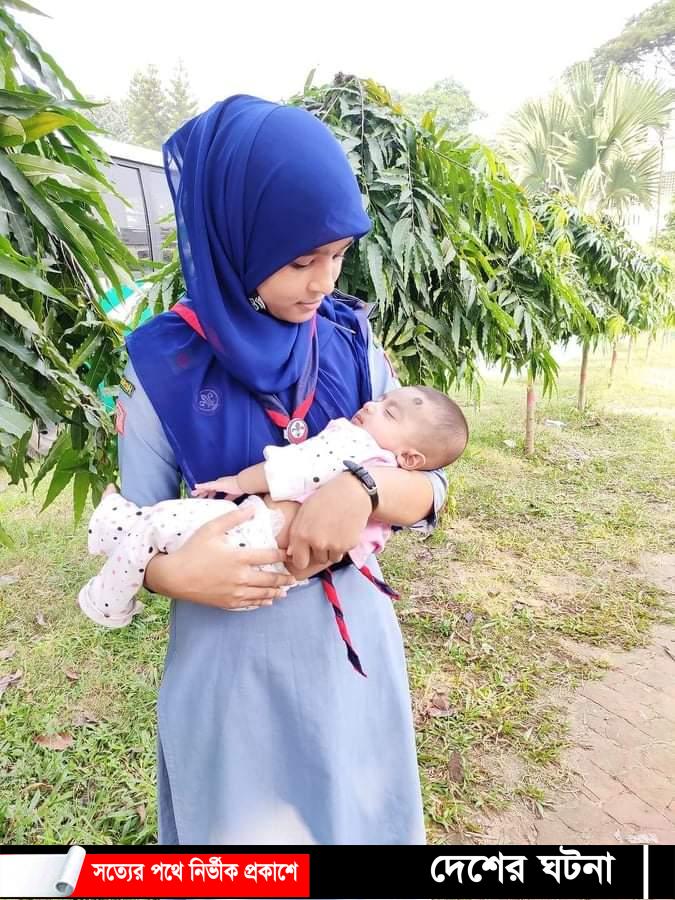 পরীক্ষার হলে মা, কোলে সন্তান নিয়ে বাইরে দাড়িয়ে স্কাউট কর্মী